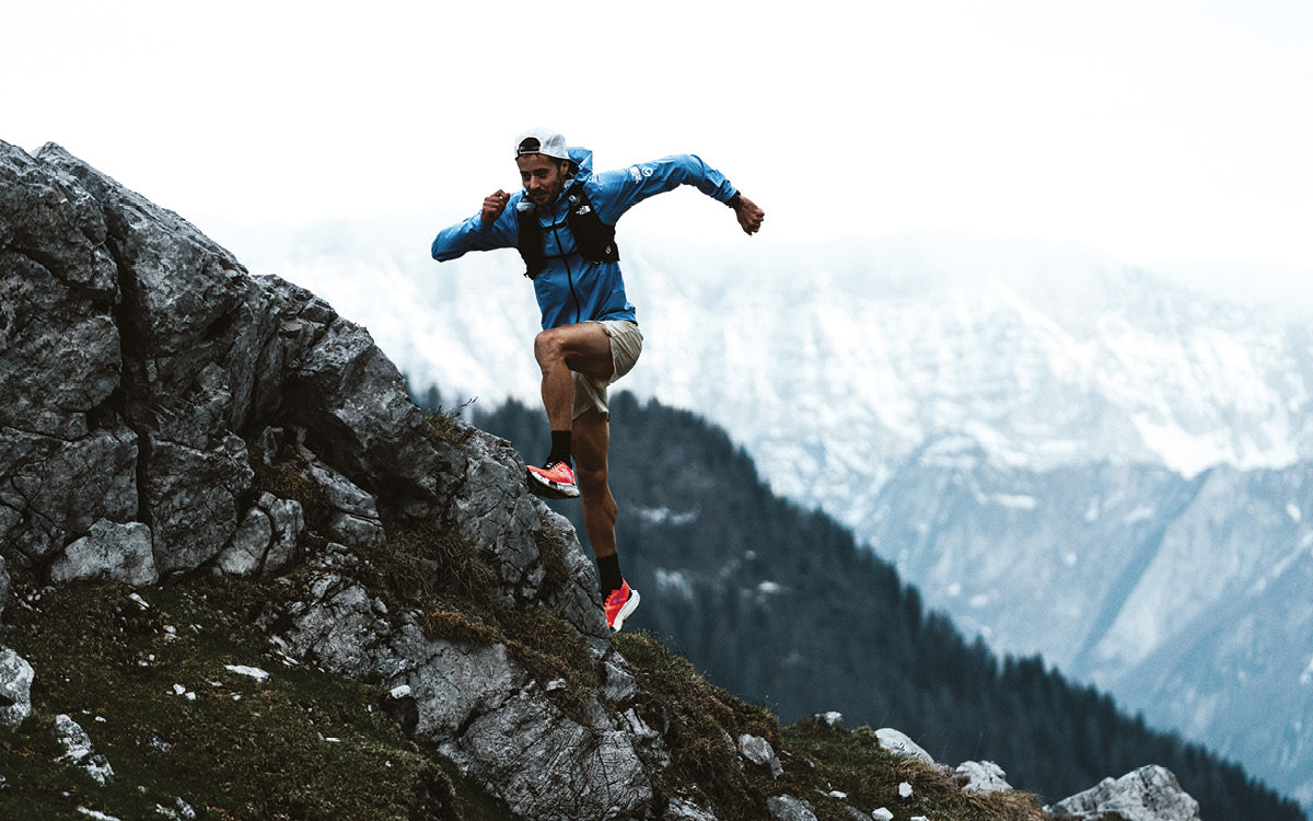 Atleta che corre in montagna indossando la collezione da trail running the north face